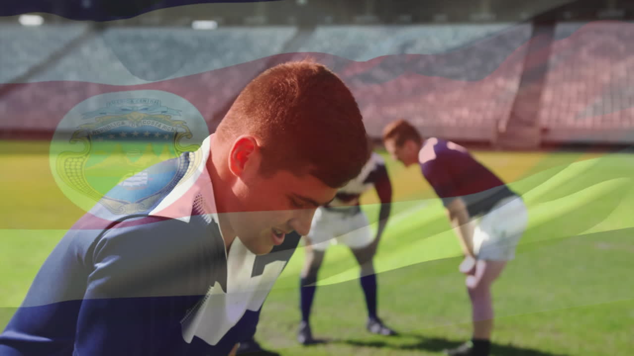 Strategizing on field, rugby players with Costa Rica flag animation overlay