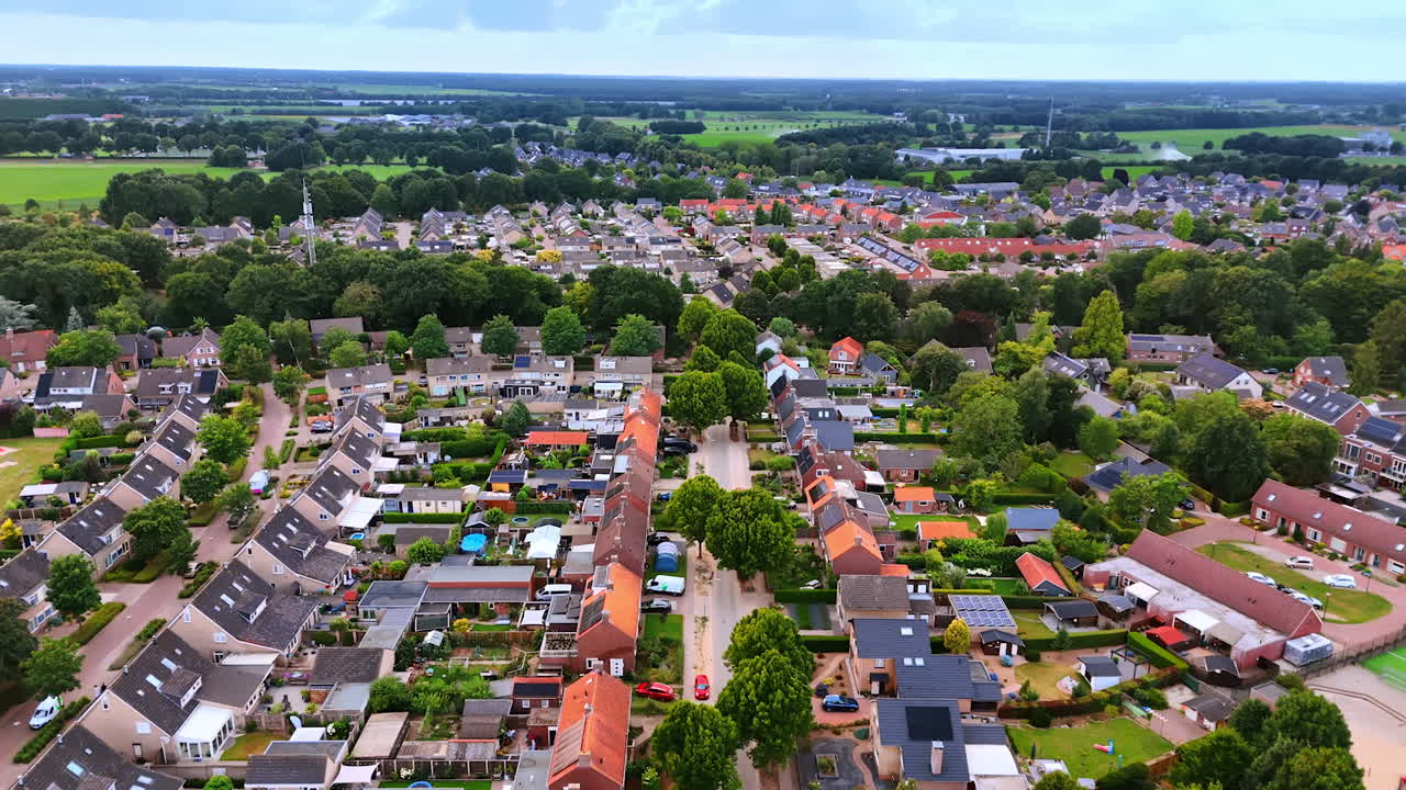 Beautiful residential area with lovely houses and lots of greenery. Footage over the town in the Netherlands