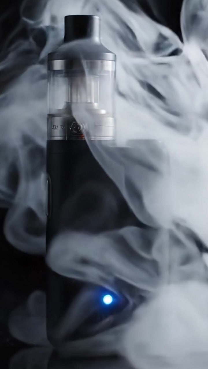 An Elegant Vape Device Emitting Clouds of Vapor in a Dark Atmosphere, Capturing the Modern Trend of Vaping Culture with Sophistication and Style