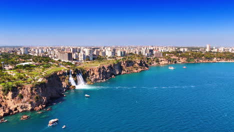 flying over the blue waterscape of the beautiful mediterranean sea. approaching stunning duden waterfalls in antalya, turkey