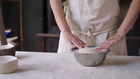 woman making ceramic bowls