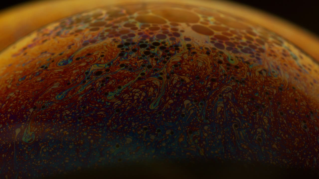 Liquid Soap Swirling in Motion with Different Color Hues on Surface