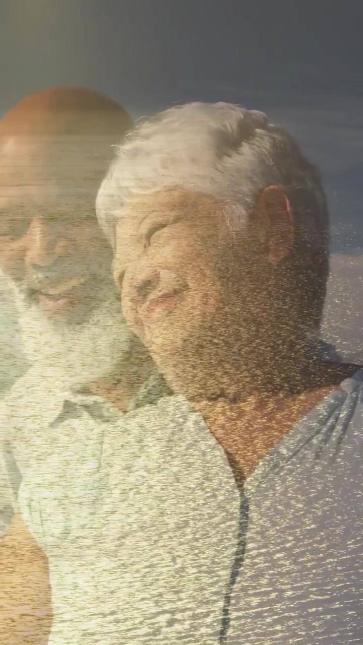 Vertical video: Couple at beach man stepping in placing arm sparkle on faces health ad