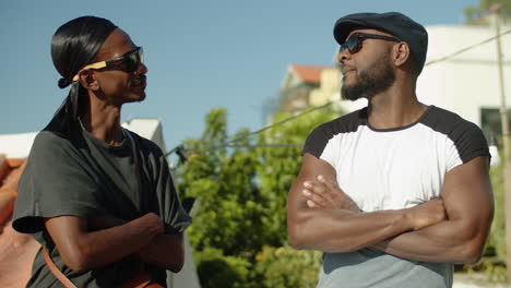 medium shot of afro-american homosexual guys talking for fun outdoor