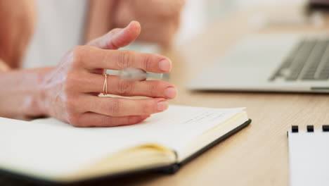 woman writing in a notebook at a desk