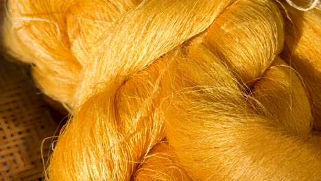 golden silk threads displayed in woven baskets