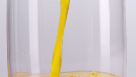 orange juice pouring into glass