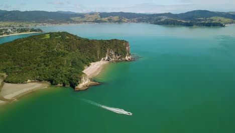 tour boat departing marina and setting off to see the sights of the coromandel peninsula in new zealand