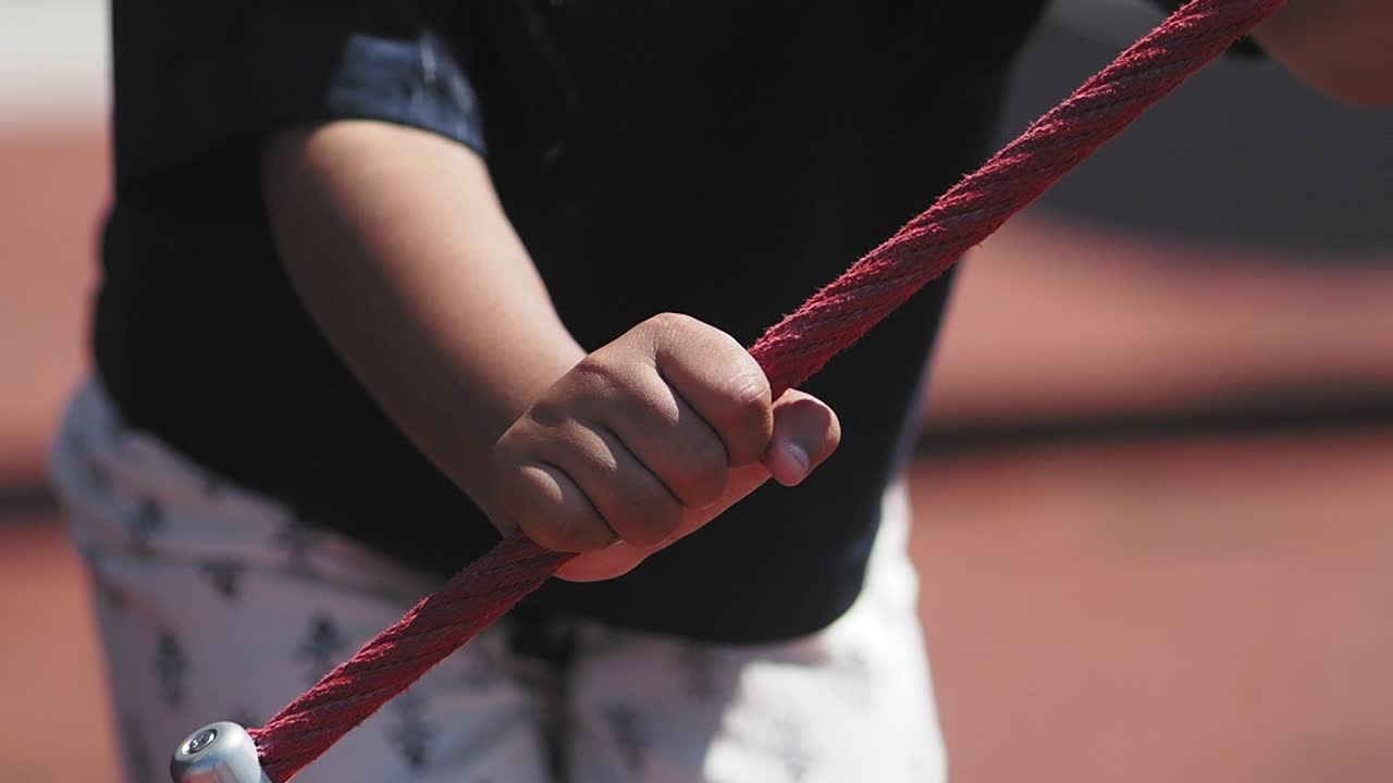 Child's Hand Holding Rope