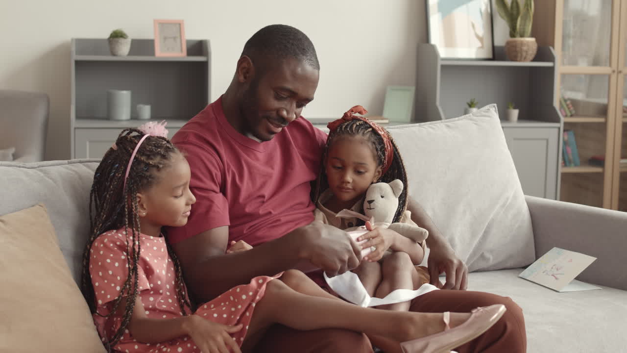 African Dad Opening Gift from Kids