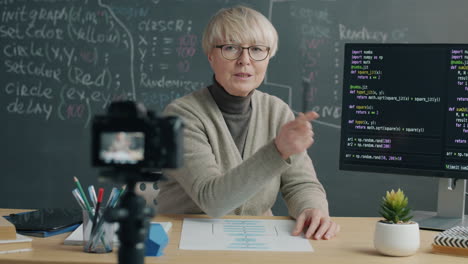 senior female teacher explaining computer science concepts