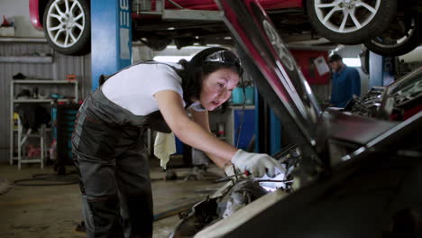 Woman-repairing-car