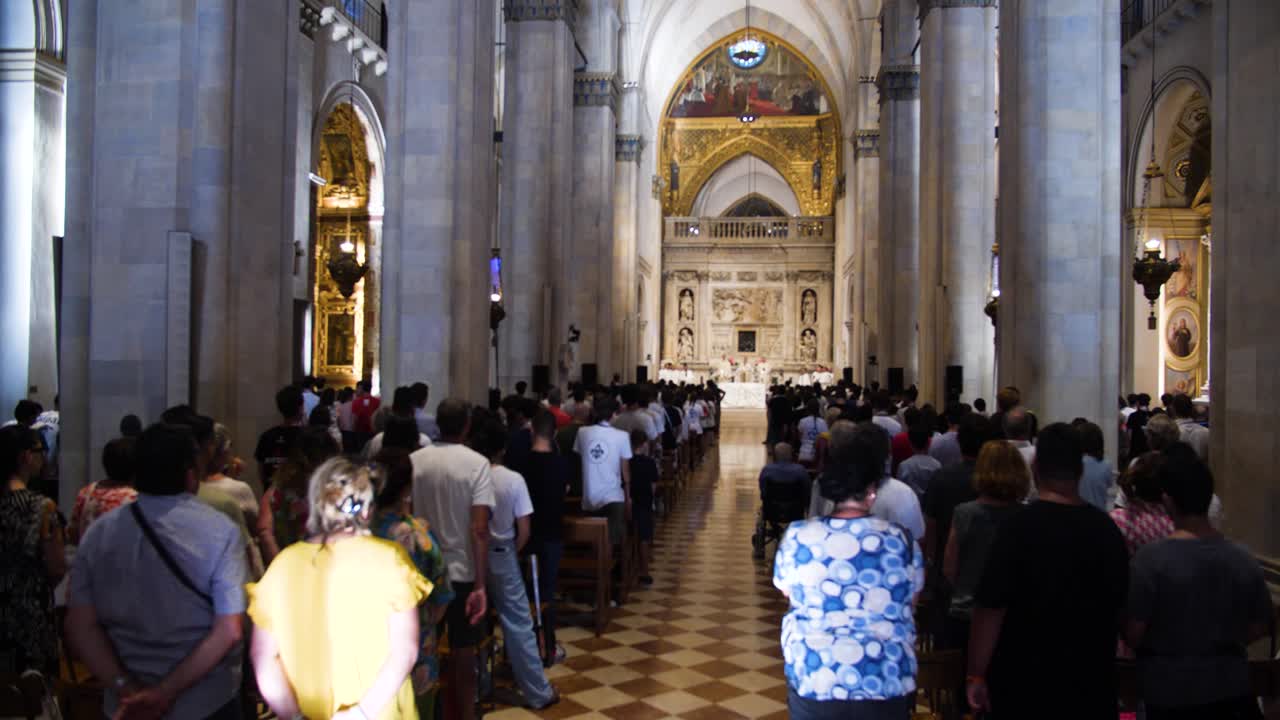 Large Congregation at a Catholic Mass in a Grand Cathedral