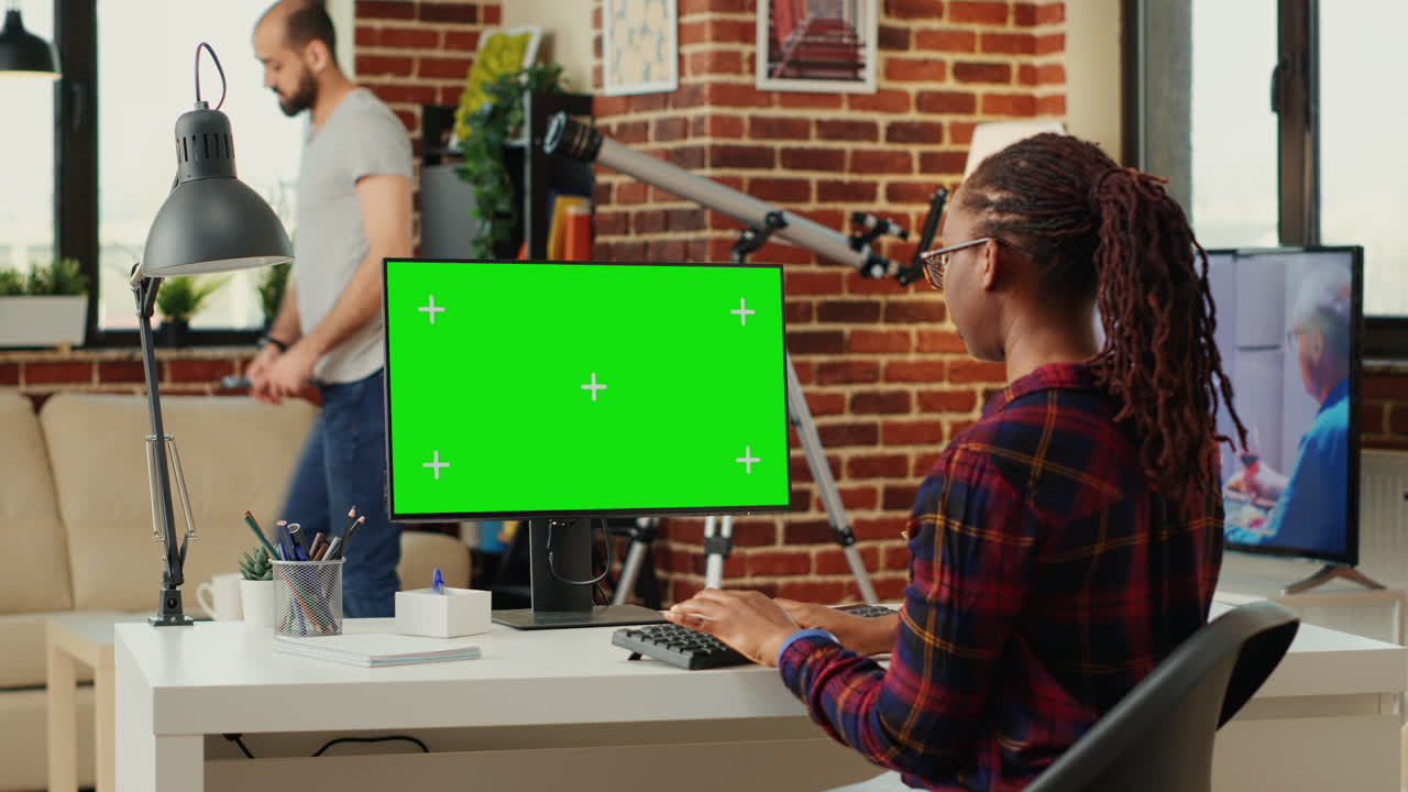 Office worker analyzing isolated greenscreen template on personal computer