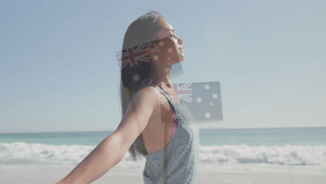 beach with animation of australian flag overlaying silhouette of woman walking
