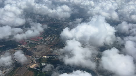 An-aerial-view-of-the-clouds-and-cityscape-below-the-clouds