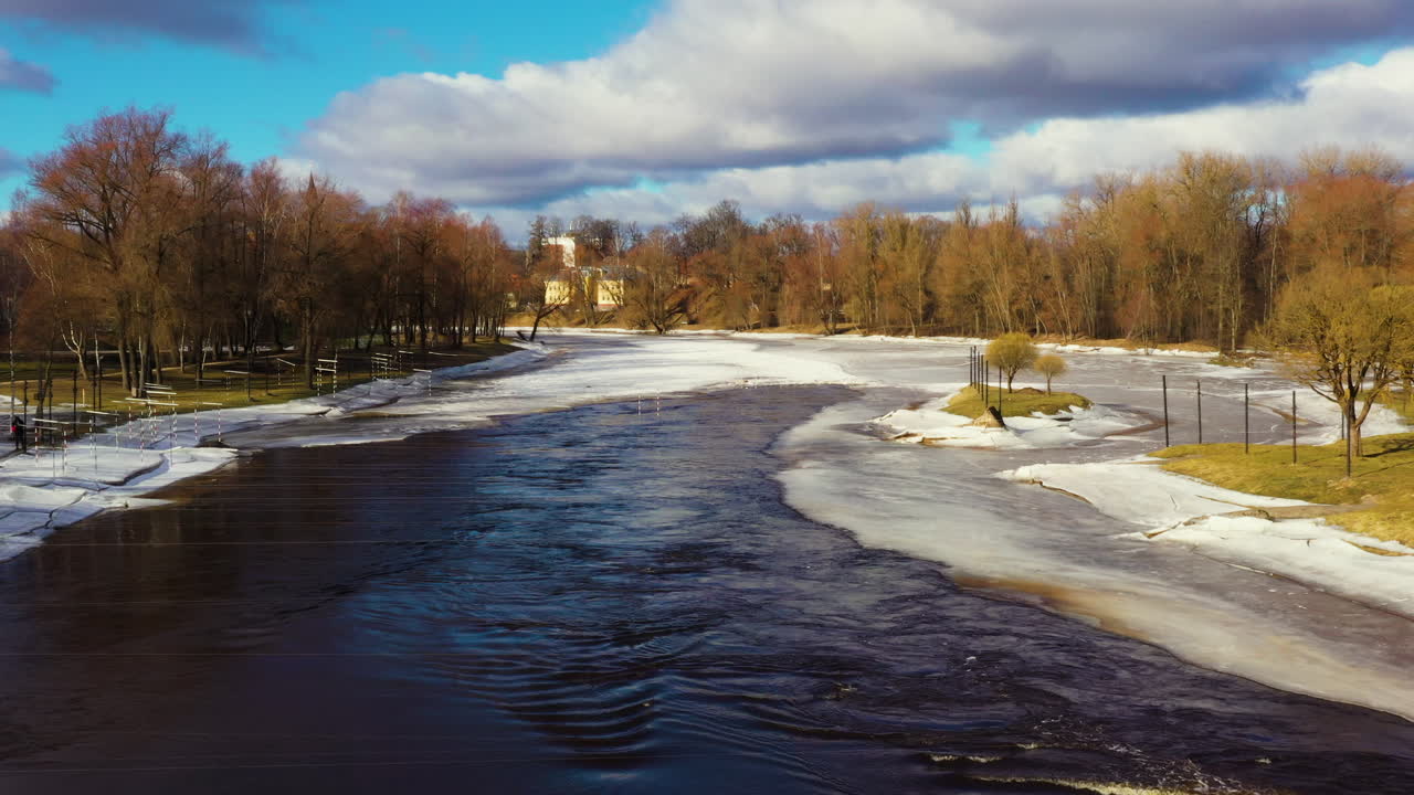 Canoe track gates in quick flowing icy Gauja river, Valmiera Latvia, aerial dolly