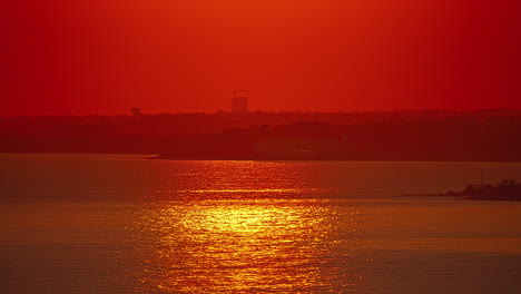 red warm summer sunset reflected on the beach of paphos coastal city in southwest cyprus