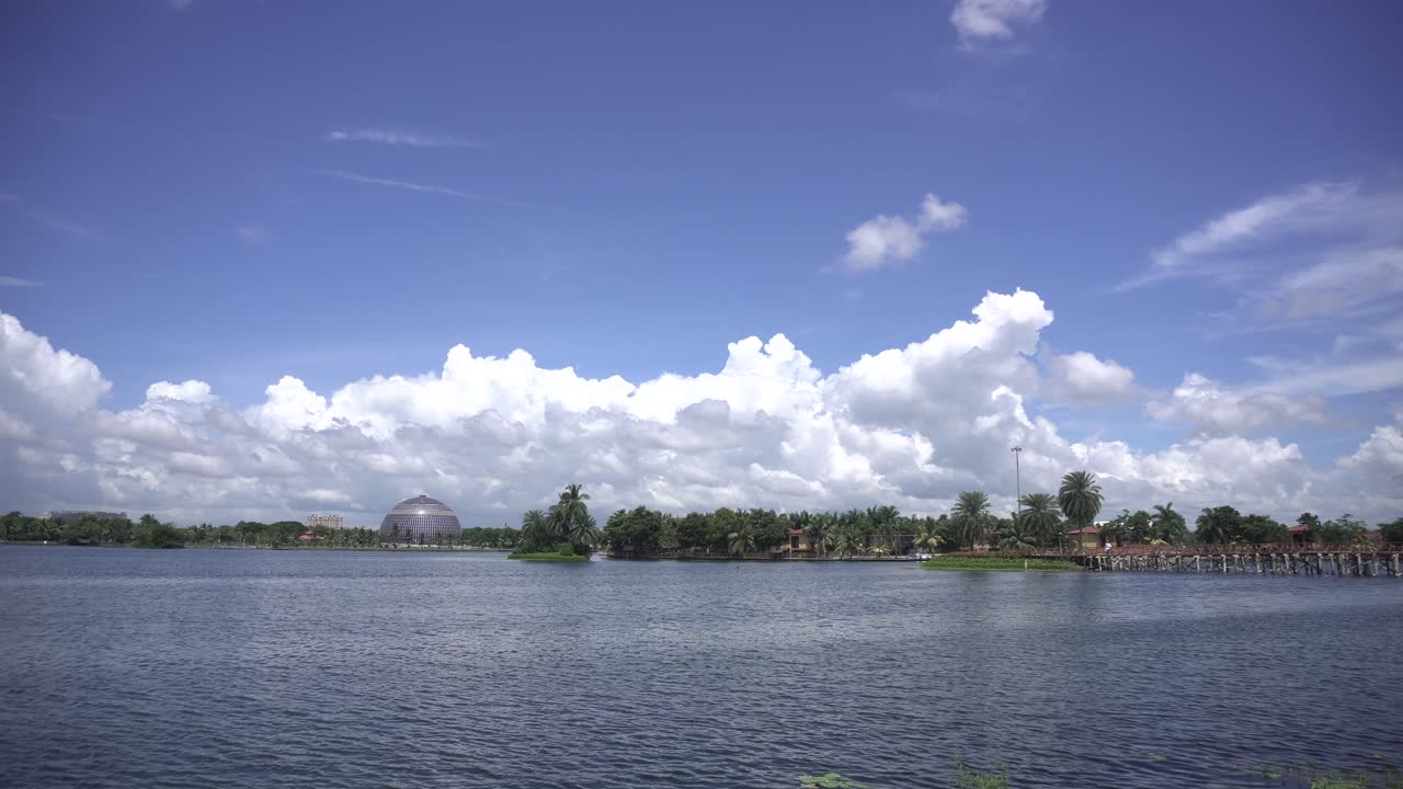 Landscape of lake, city and cloudy sky.