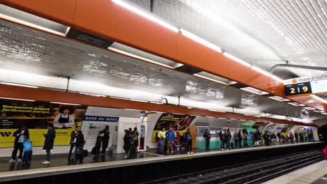 passengers waiting and boarding a subway train