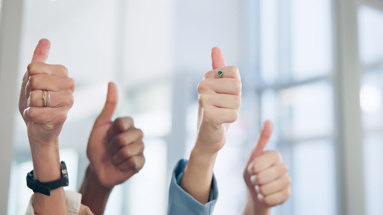 Diverse hands giving thumbs up for success