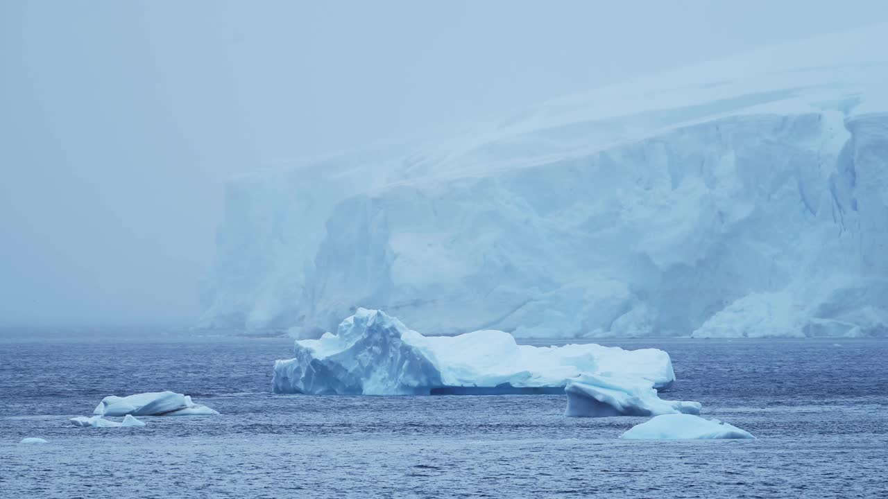 Antarctica Winter Glacier Landscape with Icebergs on Coast in Cold Blue Antarctic Peninsula Scenery with Snowy Snow, Ice and Glacier in Dramatic Beautiful Coastal Scene with Ocean Sea Water