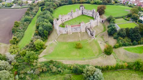 aerial: framlingham castle at countryside area in suffolk, england - drone flying forward shot