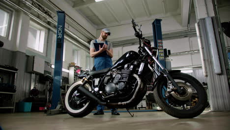 Man-with-cap-writing-at-the-garage