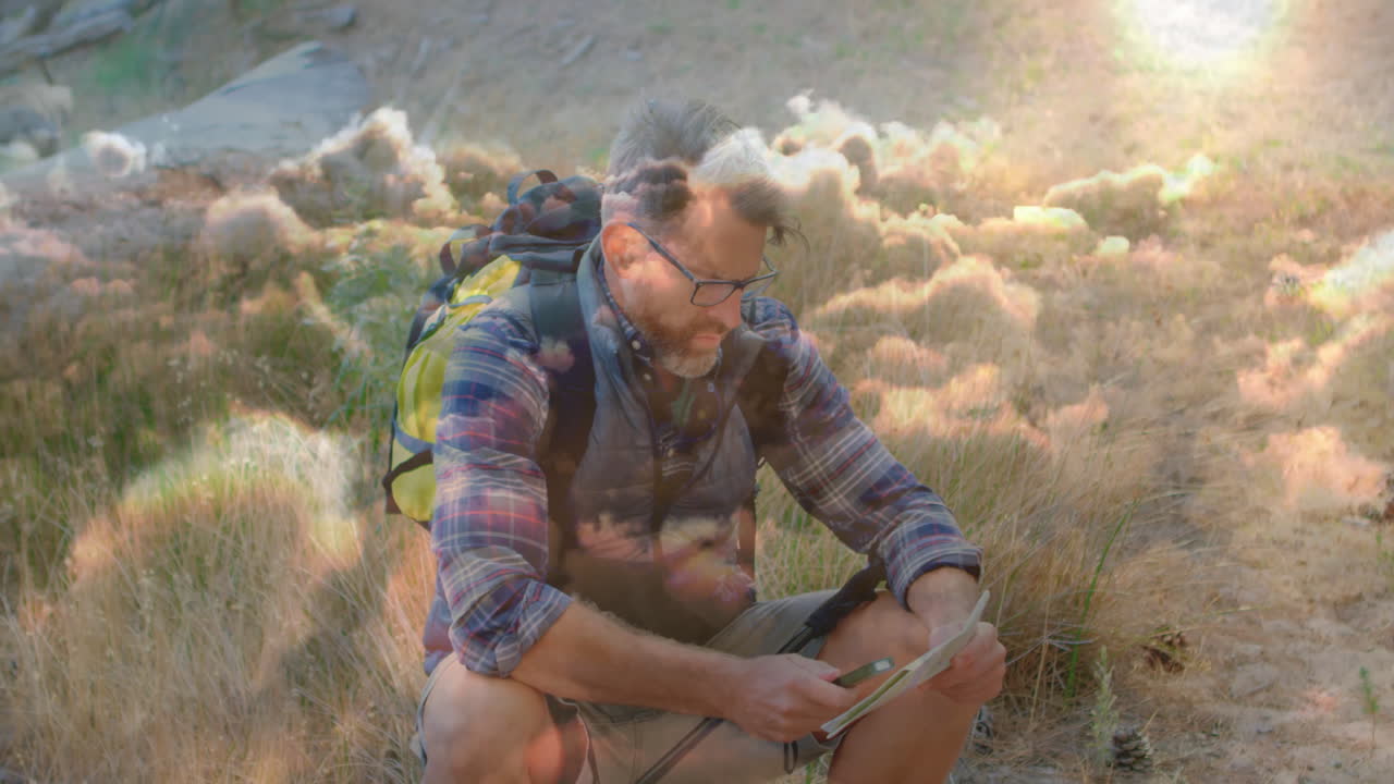 hiker crouching on dry grassland, delivering education in navigation with animated map icons