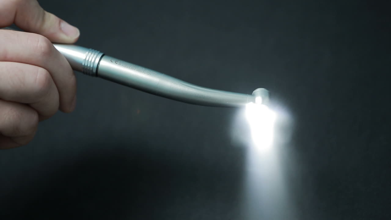 Dental Instruments in hand. Close up of dental tools on background