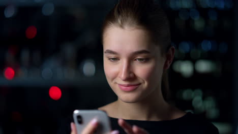 Portrait-of-smiling-girl-touching-screen-of-mobile-phone.Surfing-internet-.
