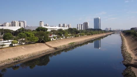 Tiete-river-reflecting-the-sky-and-buildings,-on-Marginal-Tiete-in-Sao-Paulo,-Brazil