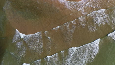 Aerial-top-down-view-of-breaking-waves-on-a-beach