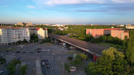 aerial view of an urban cityscape with elevated train tracks and roads