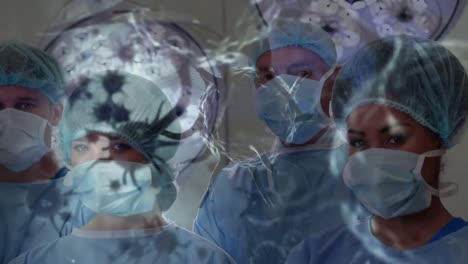 Animation-of-covid-19-cells-over-diverse-surgeons-wearing-face-masks-in-operating-theatre