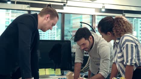 Creative-business-people-group-having-conversation-at-office-desk-in-workplace.