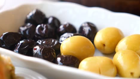 black and green olives on a plate