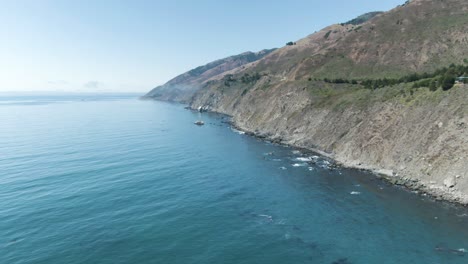 High-altitude-aerial-of-the-Pacific-Ocean-coastline-highway,-Highway-1,-in-California,-USA