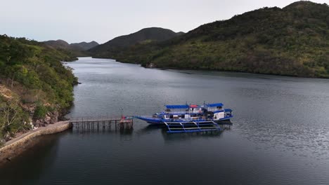 impressive drone footage of passenger - cargo ship in sitio coring, bay in western culion island, philippines