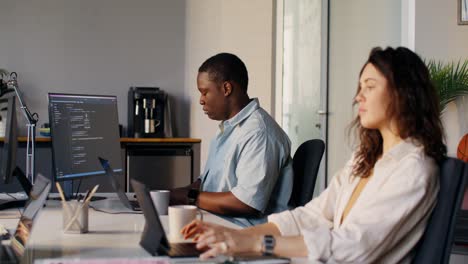 two people working on computers in modern office