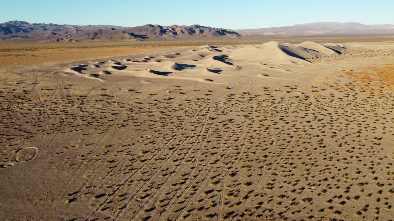 US, NV, Amargossa Valley, Big Dune, 2025-01-16 - Drone view of Big Dune, also known as Amargossa, which is a BLM sand dune in the desert. We see a fan of roads leading up to the dune at sunrise
