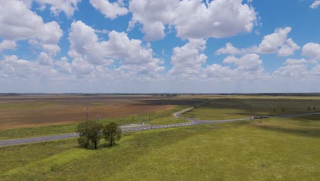 country road through farmland on a sunny day