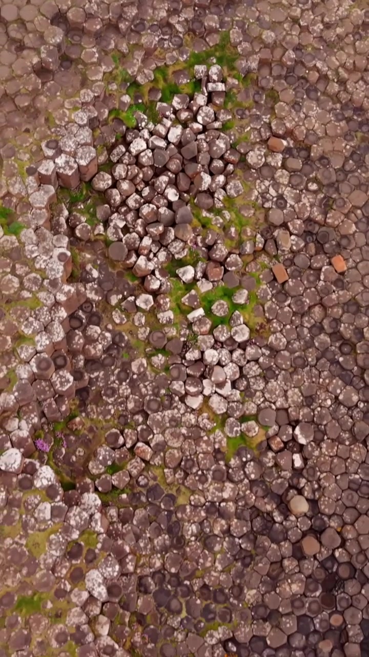 Tight overhead social ratio aerial video of The Giant's Causeway in Bushmills, County Antrim in Northern Ireland, United Kingdom. Produced in 1080x1920 vertical ratio with Rec709 color.