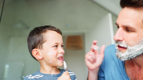 Laughing, shaving and a father teaching his son