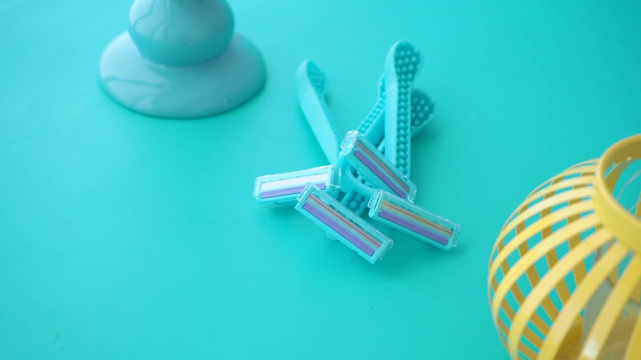 Disposable Razors on a Turquoise Background