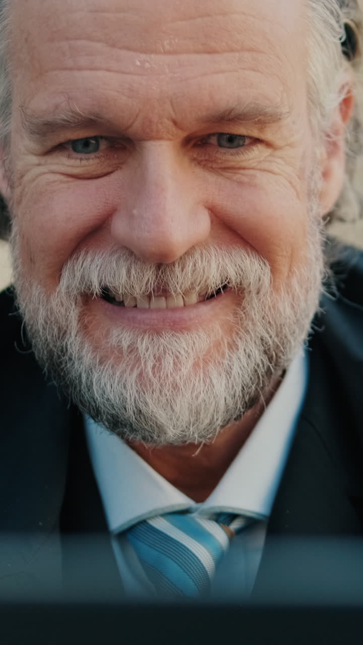 Smiling Business Man Working on Laptop at Cafe