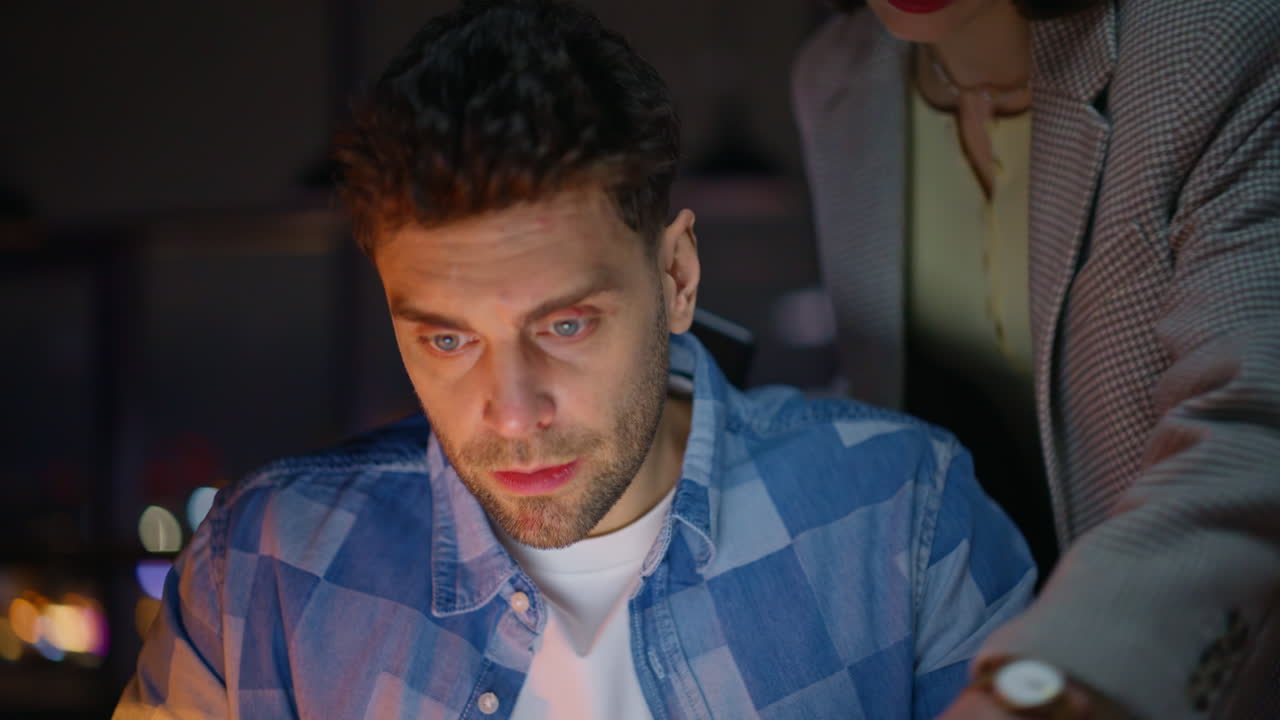 Woman guide talking intern looking laptop screen at night open space closeup