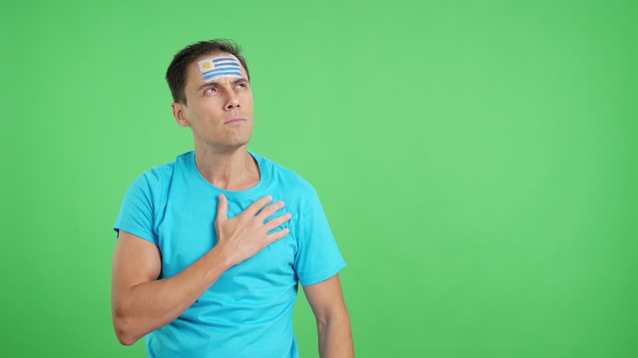 Man listening to the Uruguay national anthem with solemnity