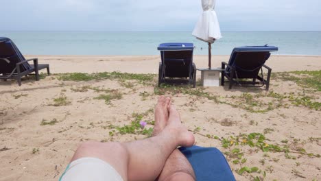 POV-of-man-walking-with-barefoot-on-white-sand-beach-in-slow-motion-in-summer-holiday-vacation