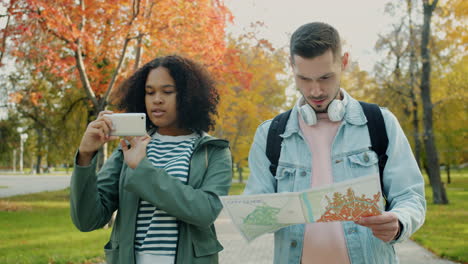 couple exploring a city park with a map